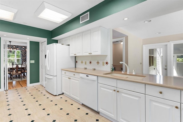 9223 Silver Lake Dr, Leesburg, FL 34788 - kitchen featuring white appliances, white cabinetry, recessed lighting, and light countertops