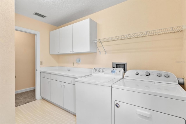 9223 Silver Lake Dr, Leesburg, FL 34788 - laundry area with cabinet space and washing machine and dryer