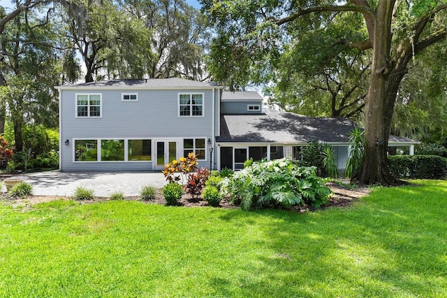 9223 Silver Lake Dr, Leesburg, FL 34788 - rear view of house featuring a patio area and a lawn