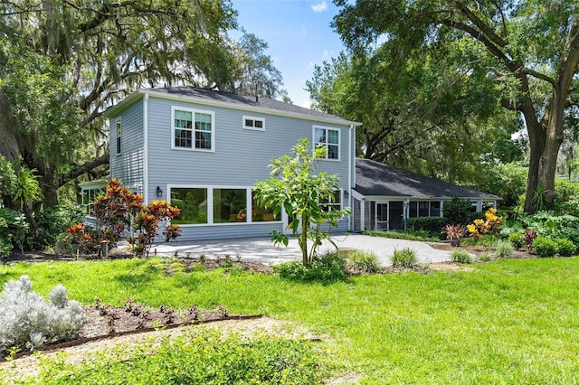 9223 Silver Lake Dr, Leesburg, FL 34788 - back of house featuring driveway and a yard