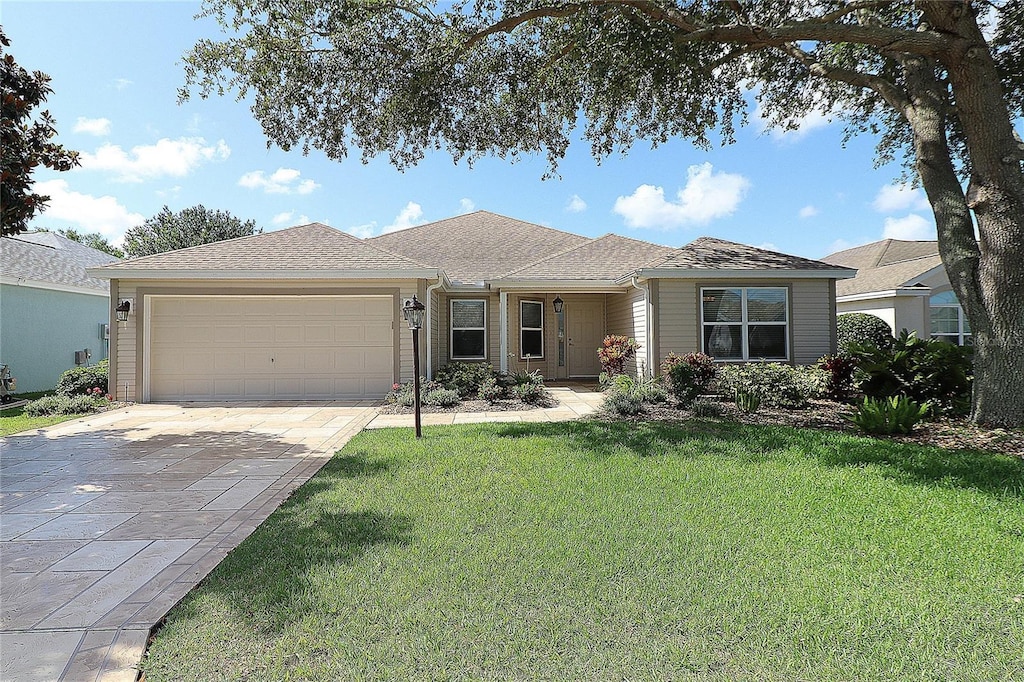 1412 Forest Acres Dr, The Villages, FL 32162 - single story home with concrete driveway, an attached garage, and a front lawn