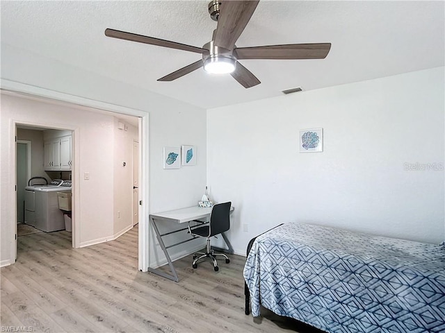 3723 Toulouse Ct, Punta Gorda, FL 33950 - bedroom with light wood-type flooring, washing machine and clothes dryer, a desk, and a ceiling fan