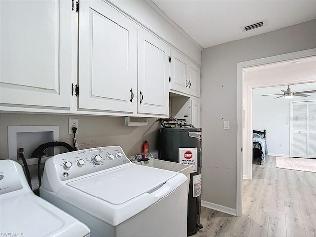 3723 Toulouse Ct, Punta Gorda, FL 33950 - laundry area with separate washer and dryer, cabinet space, light wood-style flooring, and water heater