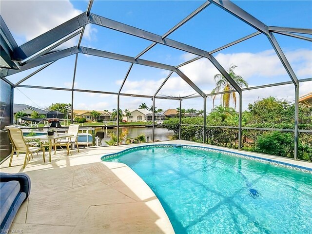 3723 Toulouse Ct, Punta Gorda, FL 33950 - swimming pool with a patio, a water view, and glass enclosure