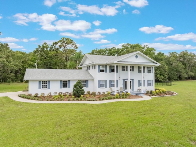5556 Round Lake Rd, Apopka, FL 32712 - neoclassical / greek revival house with a front yard, roof with shingles, and stucco siding