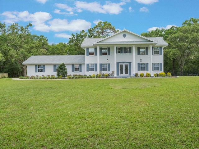 5556 Round Lake Rd, Apopka, FL 32712 - neoclassical / greek revival house with french doors, a front yard, and stucco siding