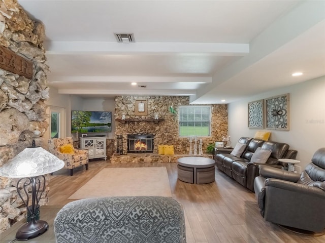5556 Round Lake Rd, Apopka, FL 32712 - living room with a stone fireplace, beam ceiling, and wood finished floors