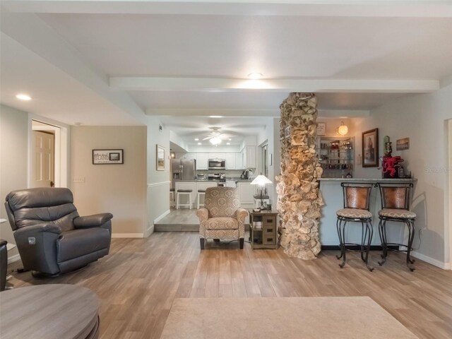 5556 Round Lake Rd, Apopka, FL 32712 - living area with light wood finished floors, beam ceiling, and a ceiling fan