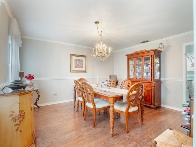 5556 Round Lake Rd, Apopka, FL 32712 - dining space with a chandelier, light wood-style flooring, and ornamental molding