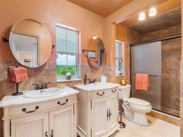 5556 Round Lake Rd, Apopka, FL 32712 - full bathroom with tile walls, a stall shower, two vanities, tile patterned floors, and a wainscoted wall