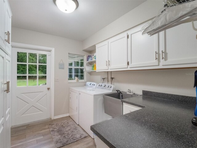 5556 Round Lake Rd, Apopka, FL 32712 - washroom featuring cabinet space, washing machine and dryer, and light wood finished floors