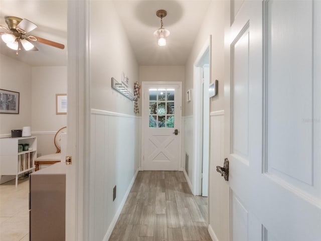 5556 Round Lake Rd, Apopka, FL 32712 - hall with wainscoting, light wood finished floors, and a decorative wall