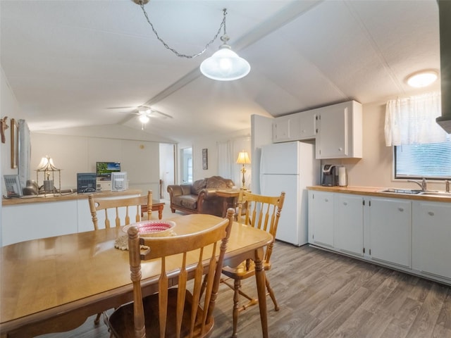 5556 Round Lake Rd, Apopka, FL 32712 - dining area featuring lofted ceiling, light wood-type flooring, and a ceiling fan