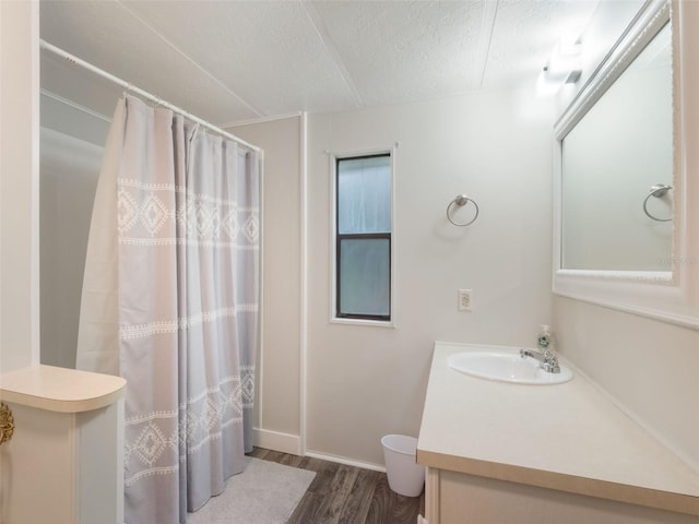 5556 Round Lake Rd, Apopka, FL 32712 - bathroom with wood finished floors, vanity, a textured ceiling, and a shower with shower curtain