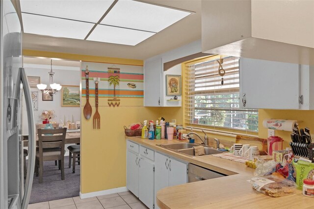 806 Leopard Trl, Winter Springs, FL 32708 - kitchen featuring light tile patterned floors, a chandelier, light countertops, white cabinets, and stainless steel fridge