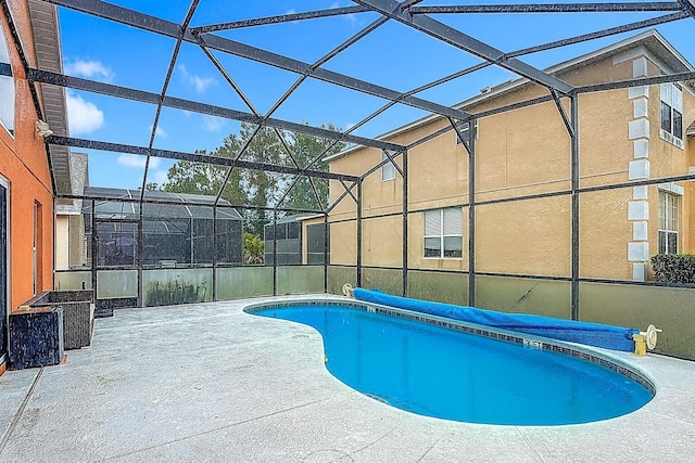 167 Castaway Beach Way, Kissimmee, FL 34746 - view of swimming pool featuring a patio area, a covered pool, and glass enclosure