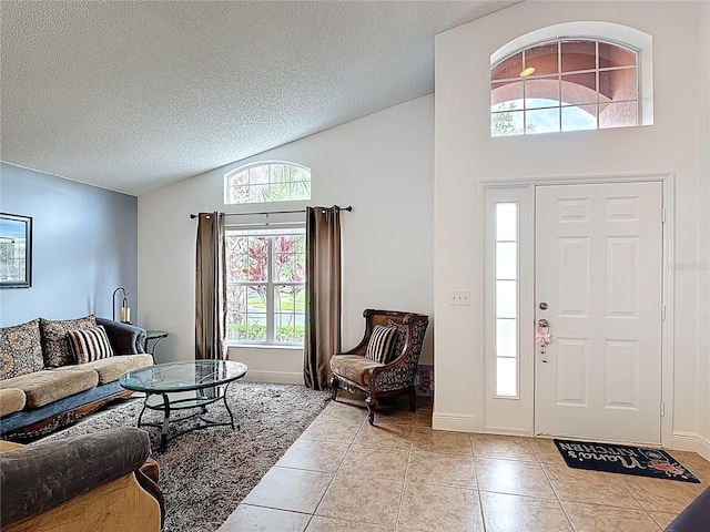 167 Castaway Beach Way, Kissimmee, FL 34746 - living room with vaulted ceiling, light tile patterned floors, plenty of natural light, and a textured ceiling