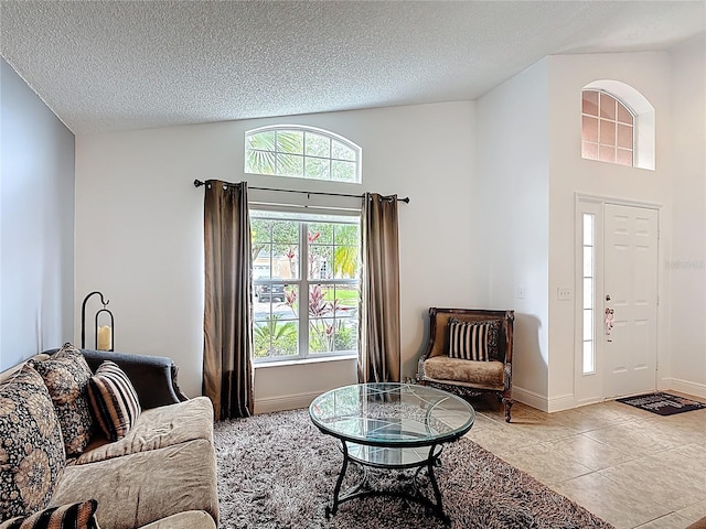 167 Castaway Beach Way, Kissimmee, FL 34746 - living area with a textured ceiling, high vaulted ceiling, and light tile patterned floors