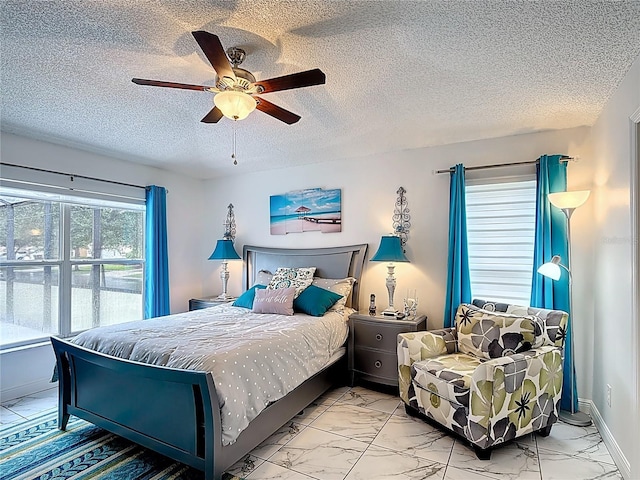167 Castaway Beach Way, Kissimmee, FL 34746 - bedroom featuring marble finish floors, ceiling fan, and a textured ceiling