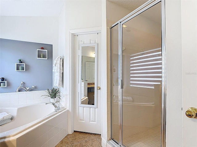 167 Castaway Beach Way, Kissimmee, FL 34746 - full bathroom with a shower stall, a garden tub, and tile patterned floors