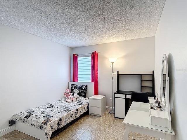 167 Castaway Beach Way, Kissimmee, FL 34746 - bedroom with a textured ceiling and baseboards