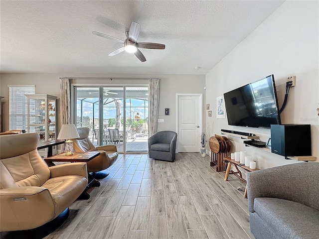 655 Conservation Blvd, Groveland, FL 34736 - living area with ceiling fan, a textured ceiling, and light wood-type flooring