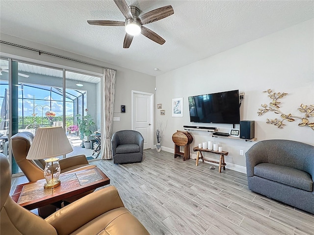 655 Conservation Blvd, Groveland, FL 34736 - living room featuring a ceiling fan, a textured ceiling, light wood-type flooring, and a sunroom