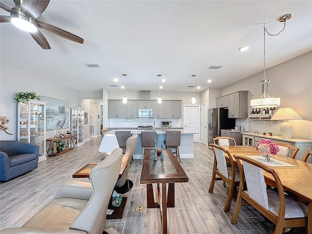 655 Conservation Blvd, Groveland, FL 34736 - living area featuring a textured ceiling, light wood-type flooring, ceiling fan, and recessed lighting