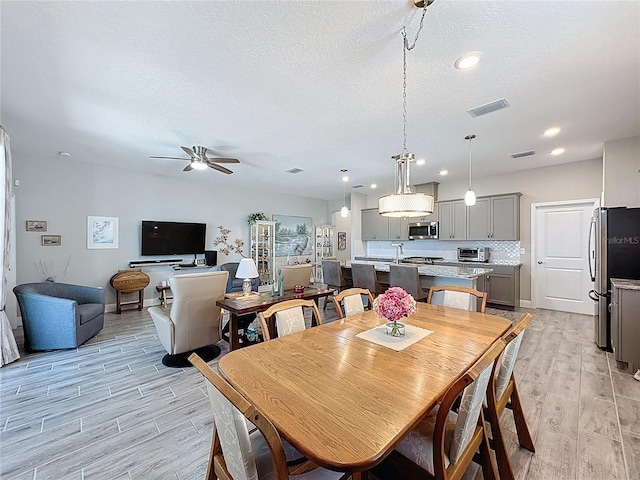 655 Conservation Blvd, Groveland, FL 34736 - dining area featuring wood tiled floors, a ceiling fan, a textured ceiling, and recessed lighting