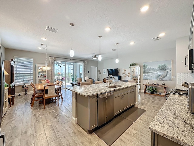 655 Conservation Blvd, Groveland, FL 34736 - kitchen featuring appliances with stainless steel finishes, gray cabinets, light wood finished floors, a ceiling fan, and a textured ceiling