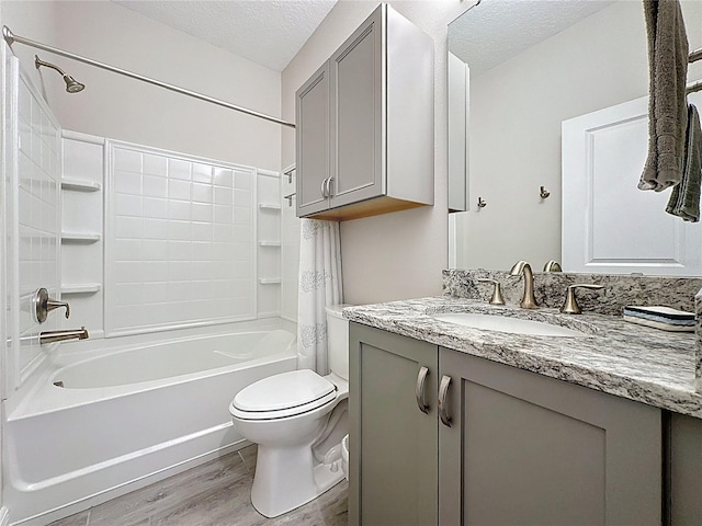 655 Conservation Blvd, Groveland, FL 34736 - full bath featuring wood finished floors, a textured ceiling, vanity, and shower / bathtub combination with curtain