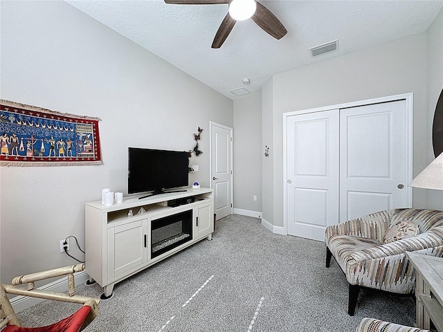 655 Conservation Blvd, Groveland, FL 34736 - living area featuring a ceiling fan, light colored carpet, and a textured ceiling