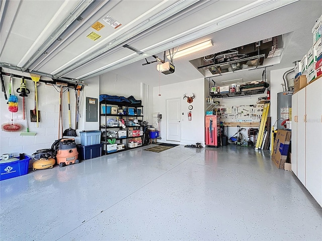 655 Conservation Blvd, Groveland, FL 34736 - garage with a garage door opener, electric panel, and water heater