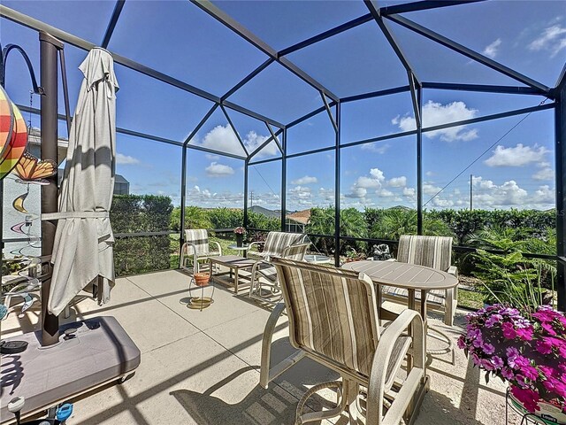 655 Conservation Blvd, Groveland, FL 34736 - view of patio / terrace featuring glass enclosure and outdoor dining area