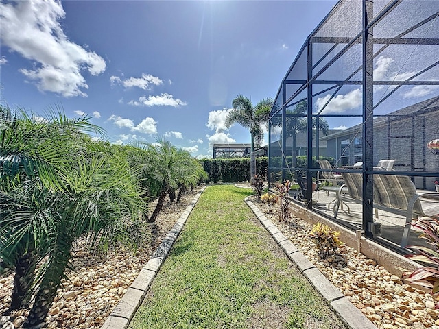 655 Conservation Blvd, Groveland, FL 34736 - fenced backyard featuring a patio and glass enclosure