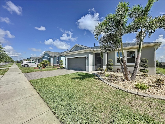 655 Conservation Blvd, Groveland, FL 34736 - single story home featuring stucco siding, driveway, a garage, and a front yard