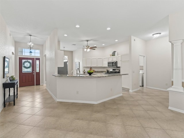 487 Thistledown Way, The Villages, FL 32162 - kitchen with appliances with stainless steel finishes, ceiling fan, white cabinets, washer / clothes dryer, and a peninsula