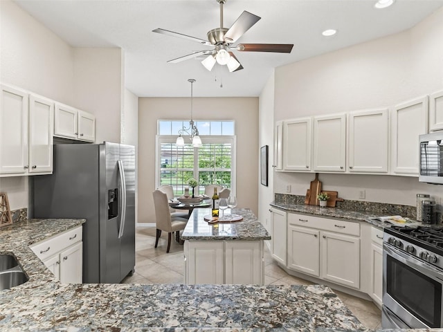 487 Thistledown Way, The Villages, FL 32162 - kitchen with stainless steel appliances, stone counters, and light tile patterned floors