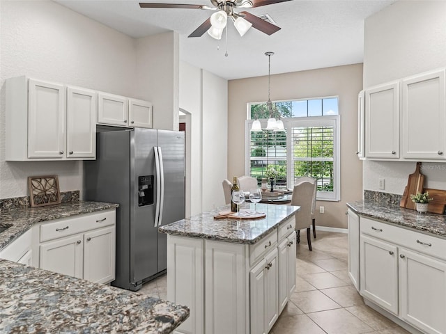 487 Thistledown Way, The Villages, FL 32162 - kitchen with stainless steel fridge, a ceiling fan, a chandelier, stone counters, and white cabinetry
