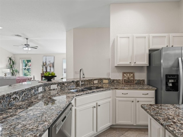 487 Thistledown Way, The Villages, FL 32162 - kitchen featuring appliances with stainless steel finishes, ceiling fan, dark stone countertops, and white cabinets