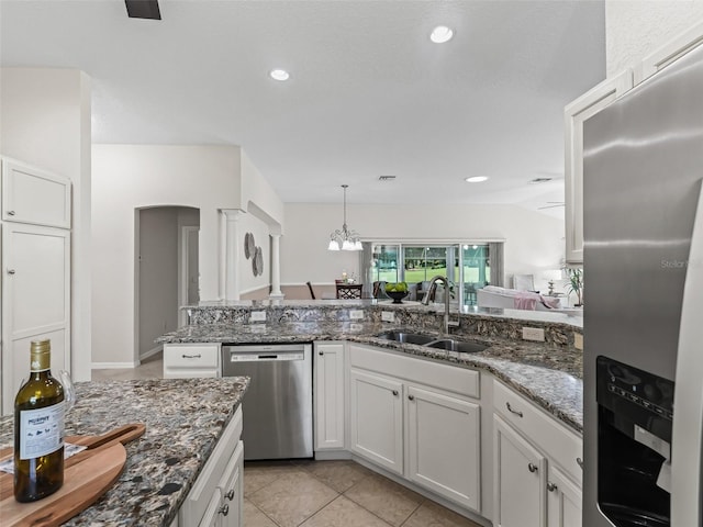 487 Thistledown Way, The Villages, FL 32162 - kitchen with appliances with stainless steel finishes, white cabinetry, dark stone countertops, hanging light fixtures, and light tile patterned floors