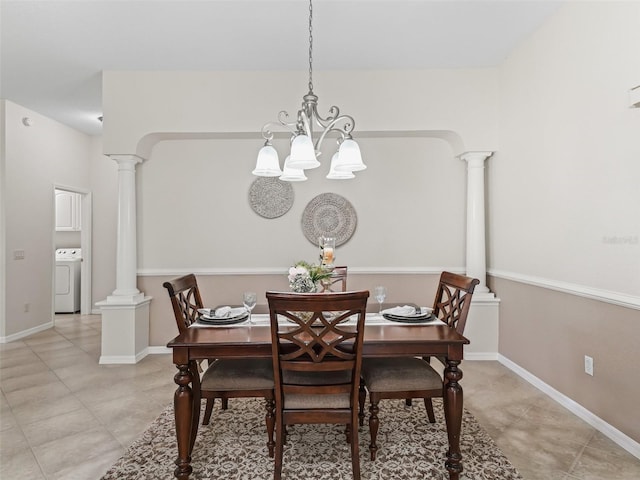 487 Thistledown Way, The Villages, FL 32162 - dining area with washer / clothes dryer, light tile patterned floors, a chandelier, and ornate columns