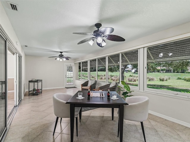 487 Thistledown Way, The Villages, FL 32162 - sunroom with a ceiling fan and outdoor dining space