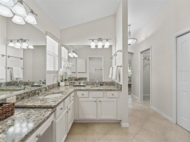487 Thistledown Way, The Villages, FL 32162 - bathroom featuring double vanity, tile patterned flooring, vaulted ceiling, and a closet
