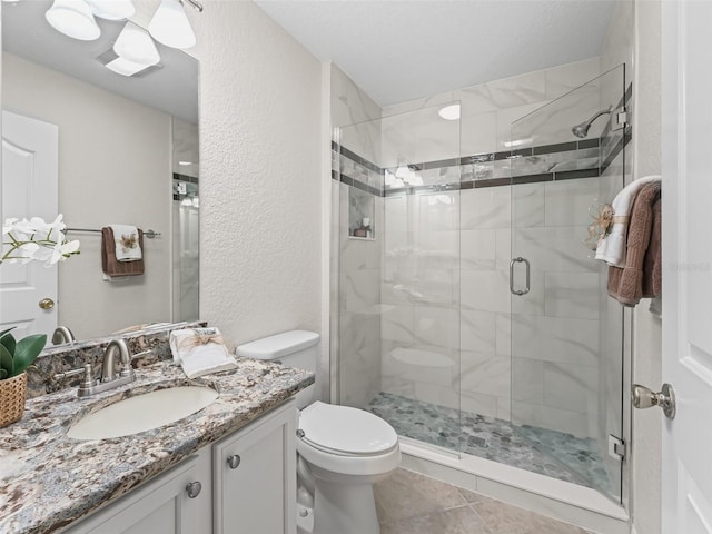 487 Thistledown Way, The Villages, FL 32162 - bathroom with a shower stall, vanity, a textured wall, and tile patterned floors