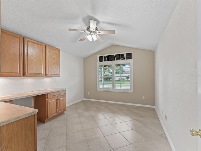 487 Thistledown Way, The Villages, FL 32162 - kitchen with ceiling fan, vaulted ceiling, light countertops, a textured ceiling, and light tile patterned floors