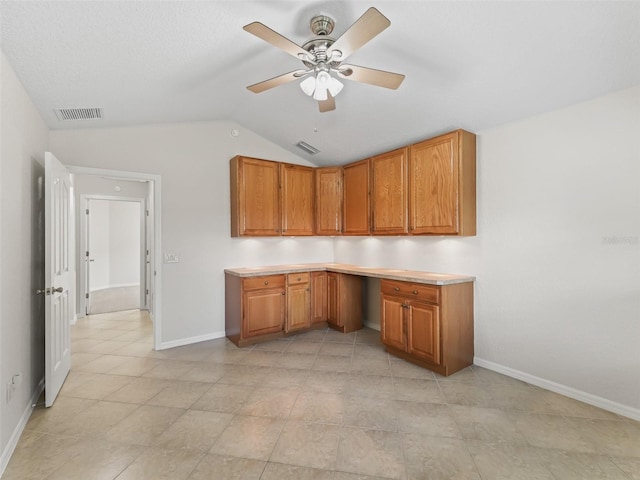 487 Thistledown Way, The Villages, FL 32162 - kitchen with lofted ceiling, ceiling fan, brown cabinets, light countertops, and built in study area