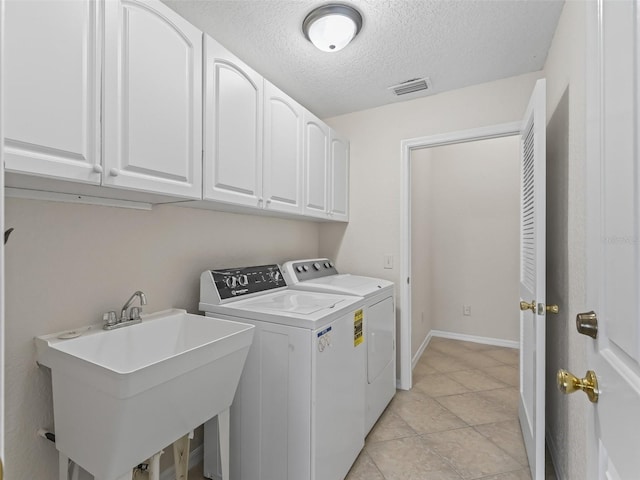 487 Thistledown Way, The Villages, FL 32162 - laundry room featuring washing machine and clothes dryer, cabinet space, and a textured ceiling