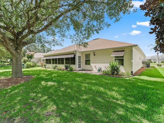 487 Thistledown Way, The Villages, FL 32162 - back of house with a yard, a sunroom, and a patio