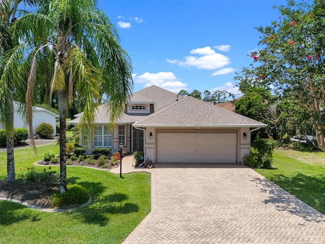 4814 Saint Andrews Arc, Leesburg, FL 34748 - view of front of home featuring decorative driveway, an attached garage, roof with shingles, and stucco siding